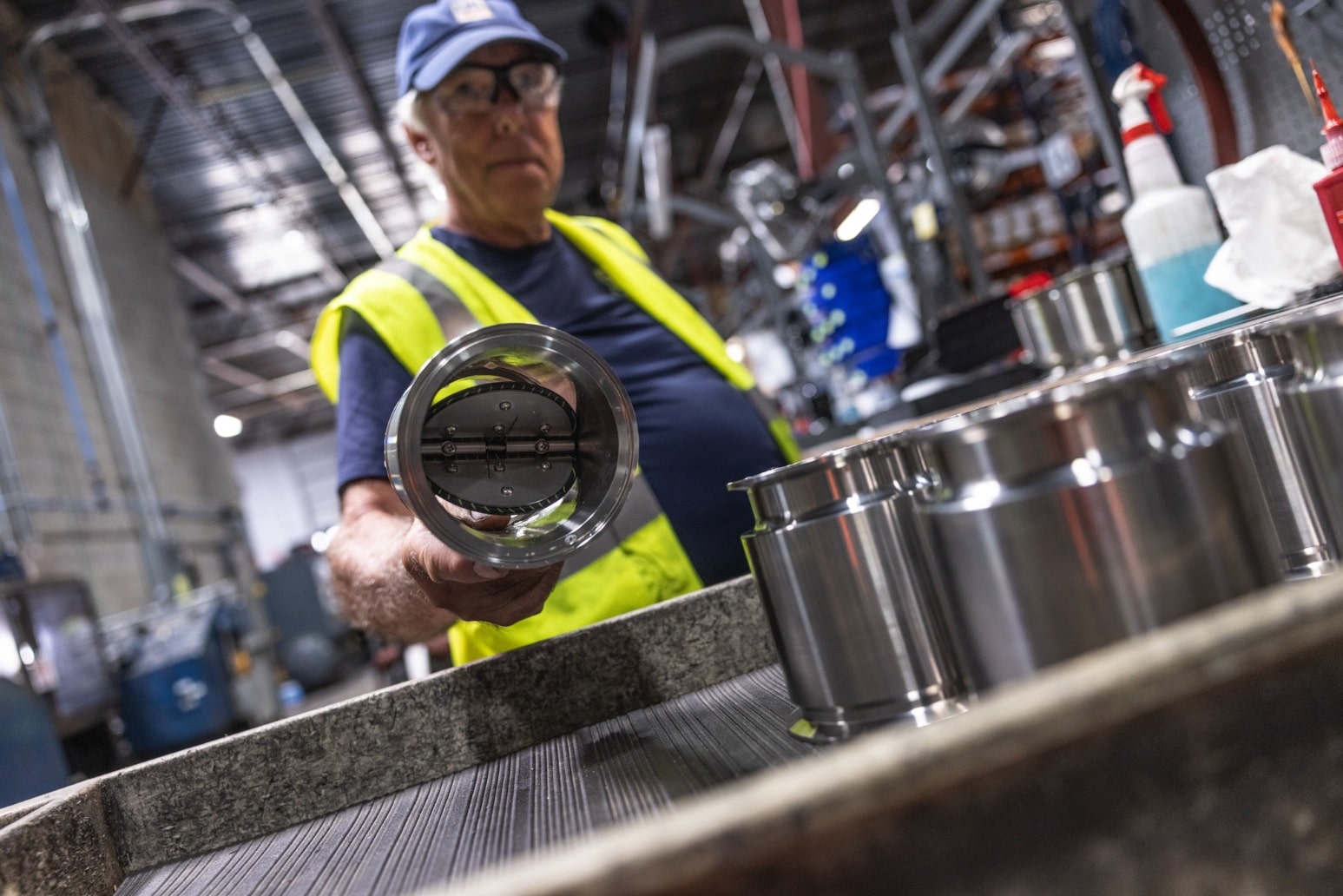 US Valve technician inspecting a wafer check valve on the production line