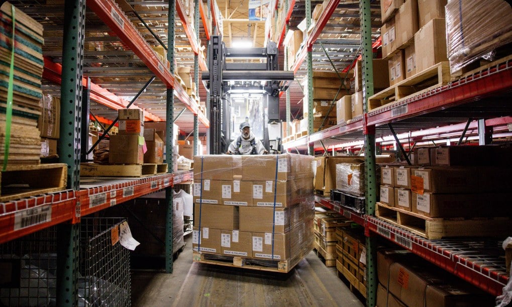 Forklift moving inventory in a global distribution warehouse