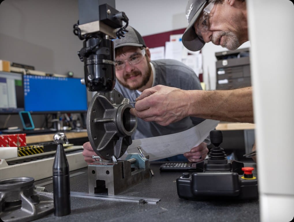 Engineer measuring a machined impeller component