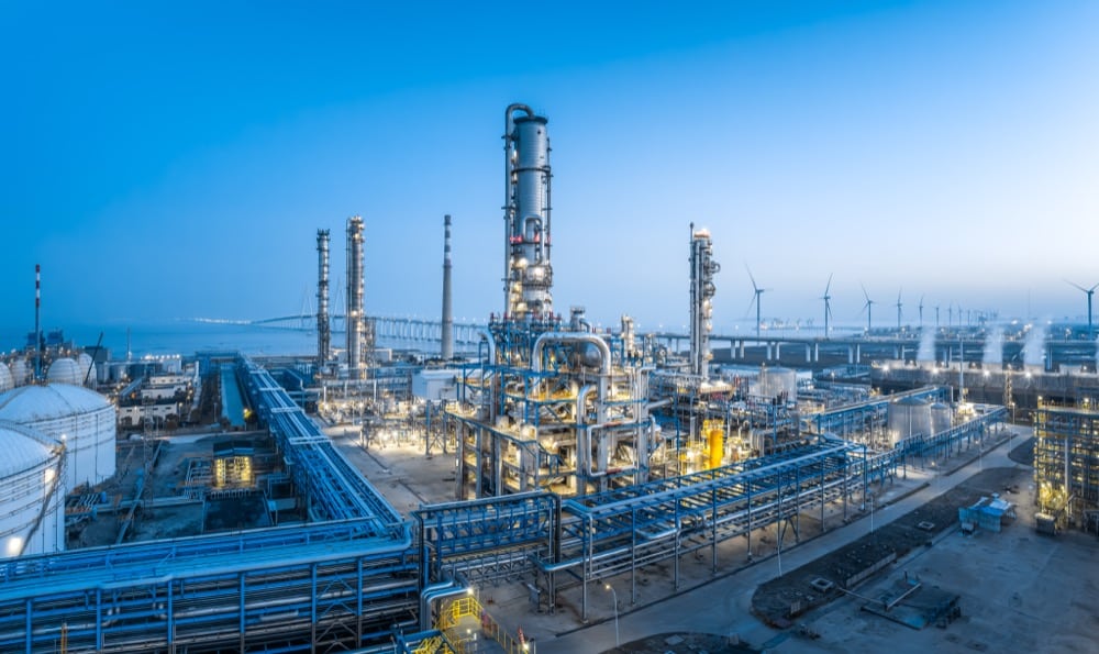 Oil and gas refinery at dusk representing demanding valve service conditions