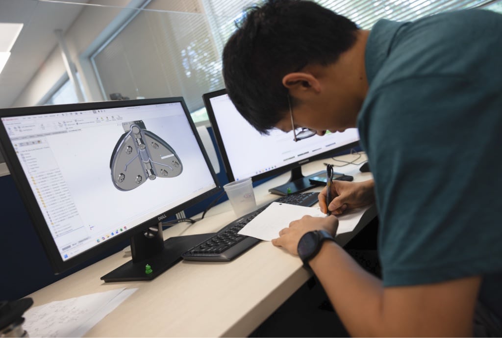 Engineer reviewing valve CAD models for laminar flow optimization