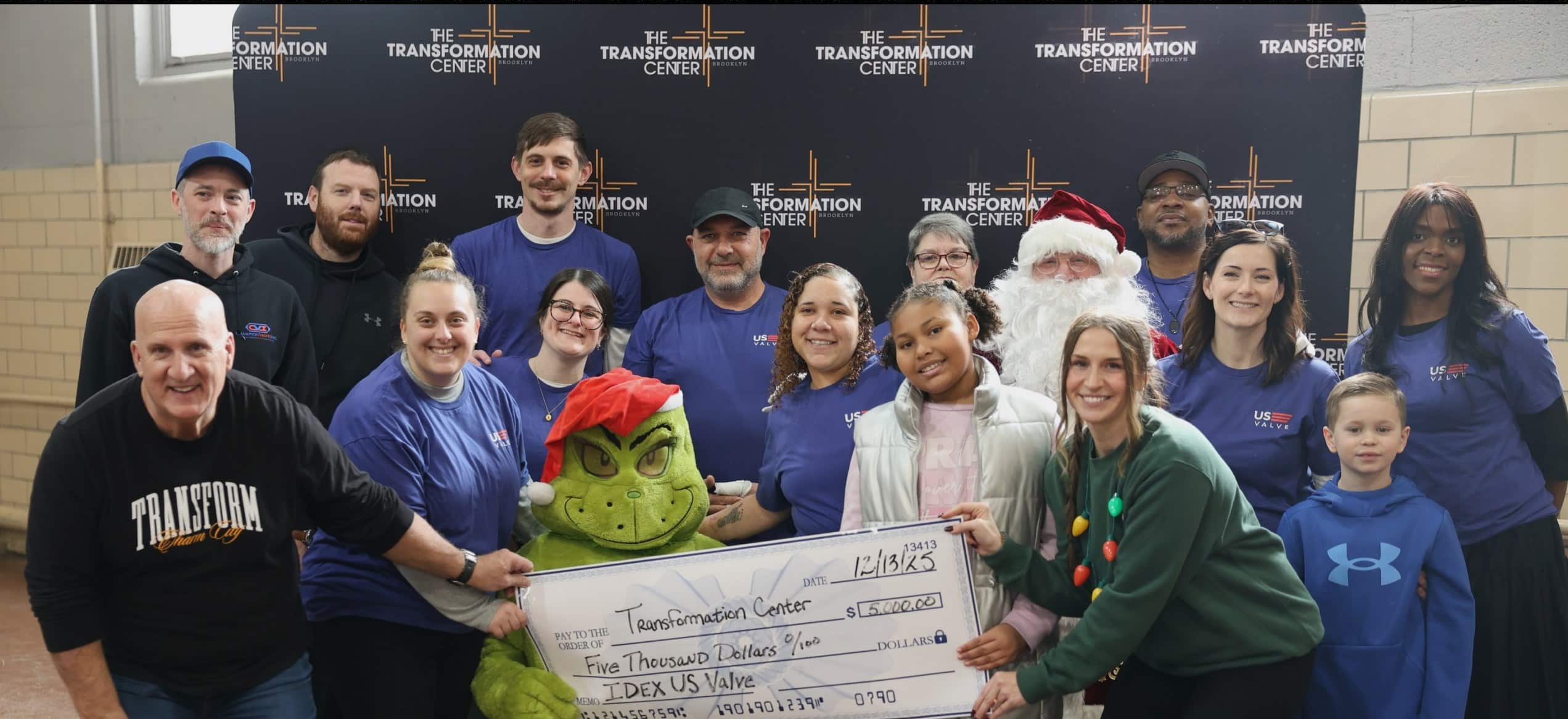 US Valve team presenting a donation check at the Transformation Center